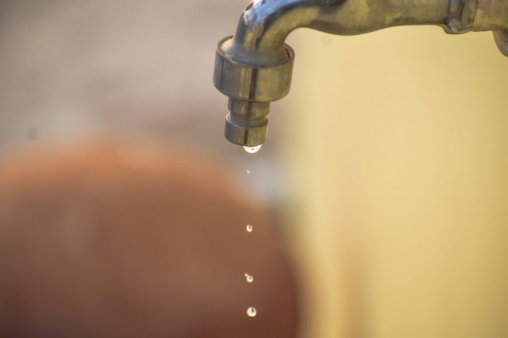 Dripping water tap, water conservation concept.
