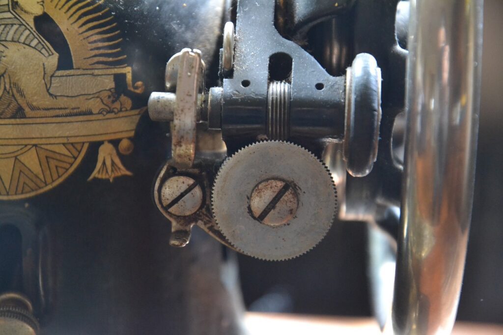Vintage sewing machine detail showcasing intricate mechanics and decorative elements, relevant to craftsmanship and local service expertise in Utica plumbing.