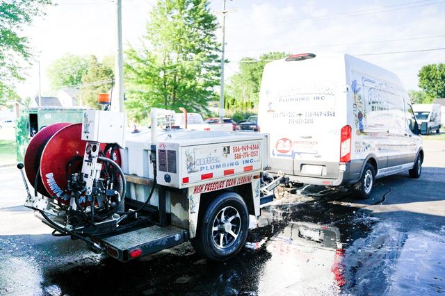 Plumbing service van and equipment on job site.